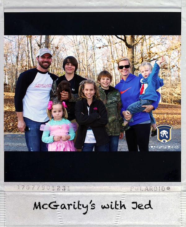 Happy McGarity family with their new Labrador Retriever puppy from LabPups.com
