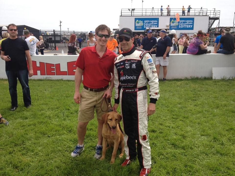 Tripper with Tim George Jr and yellow lab Vino at a NASCAR event